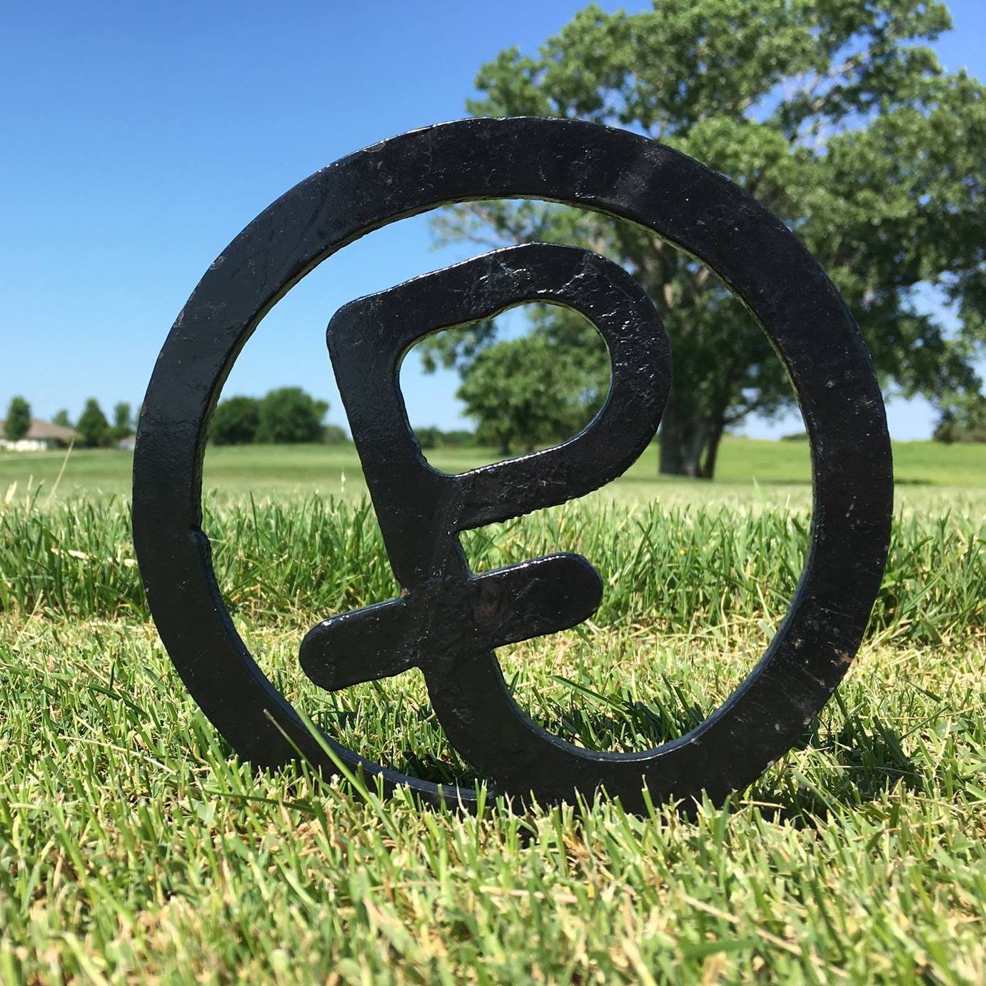 Prairie Trails golf course logo sitting in grass